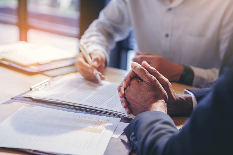 two people going over and signing a contract