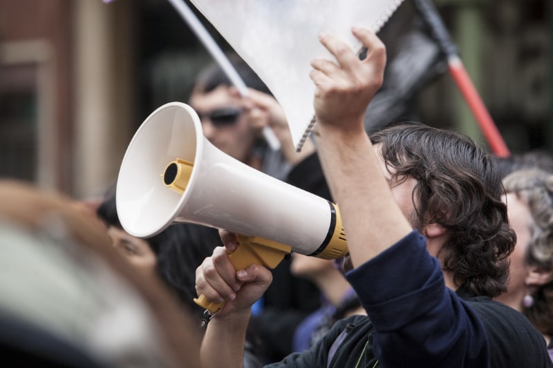 man with megaphone during protest rally